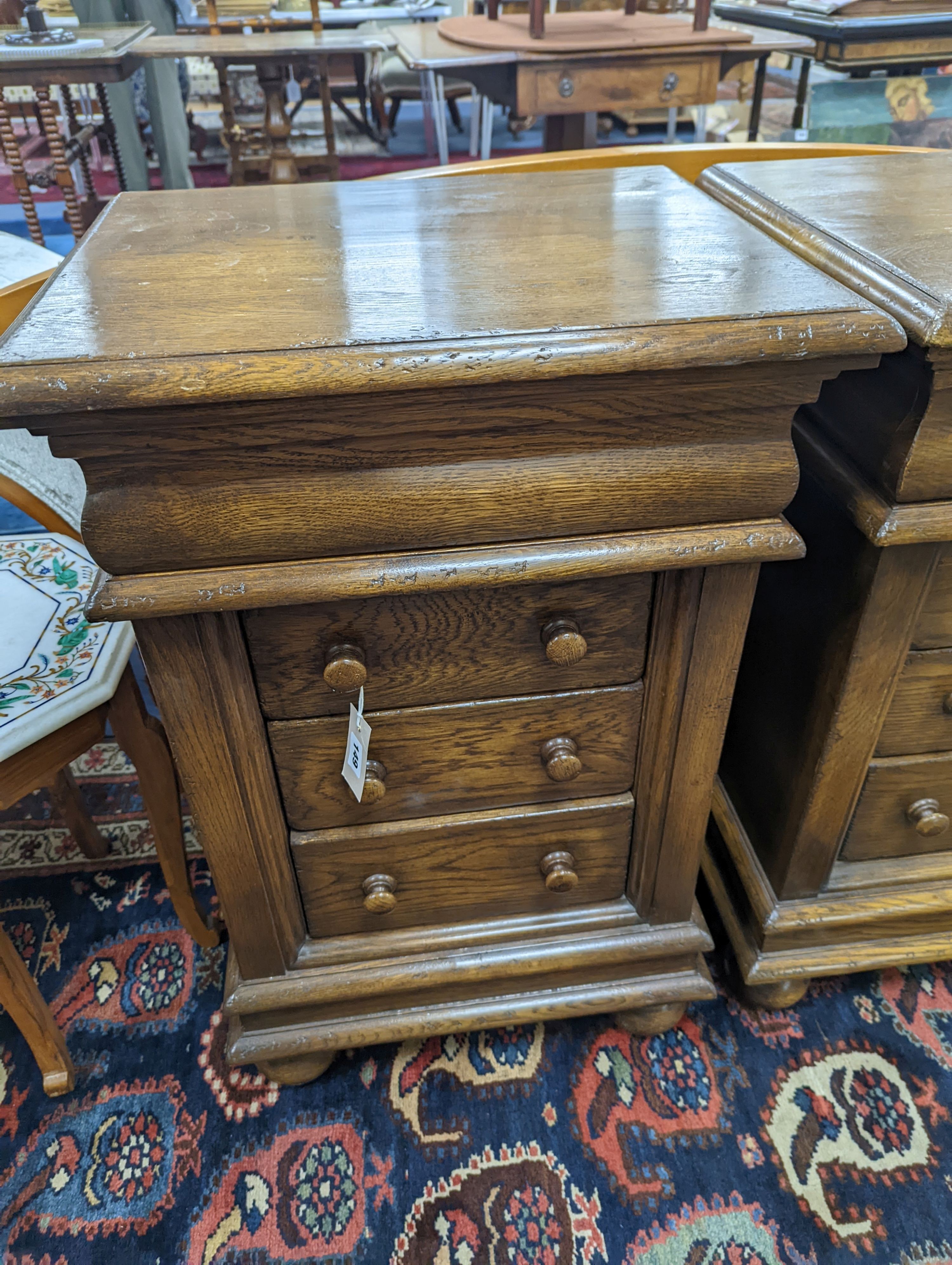 A pair of reproduction oak four drawer bedside chests, width 51cm, depth 41cm, height 79cm